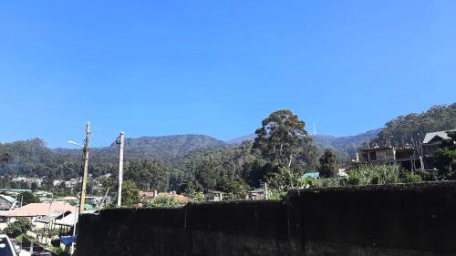 a view of a city with mountains in the background at Sapu's Mountain breeze Nuwara Eliya in Nuwara Eliya