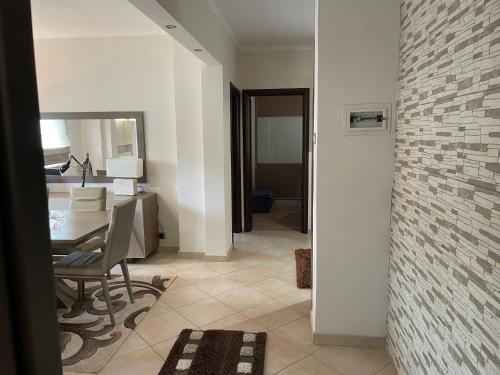 a living room with a table and a brick wall at Guest house GN in Naousa