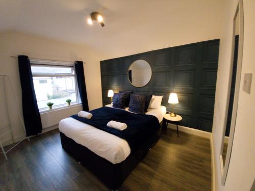 a bedroom with a large bed and a window at Double King Bed Central Apartment by Property Promise in Cardiff