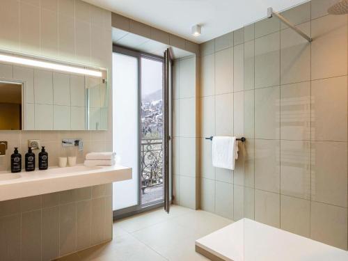 a bathroom with a shower and a sink at Le Saint Gervais Hotel & Spa Handwritten Collection in Saint-Gervais-les-Bains