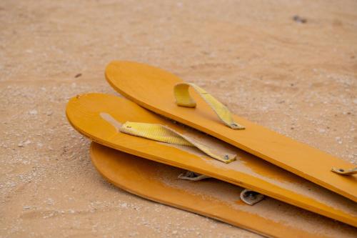 a pair of surfboards sitting on the sand at Tzila Camp in Fayoum Center