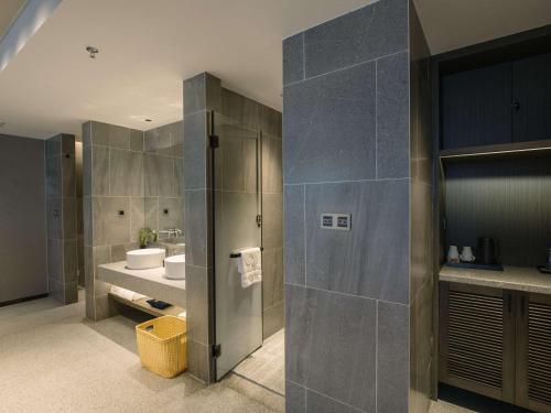 a bathroom with a toilet and a sink at Novotel Nantong Center in Nantong