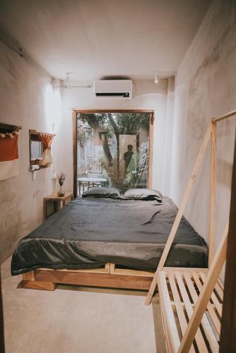 a bedroom with a bed with a painting on the wall at Thoai Mai House Phan Thiết in Ấp Bình Hưng