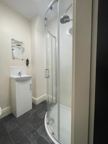a bathroom with a shower and a sink at Dinorwic Lodge in Liverpool
