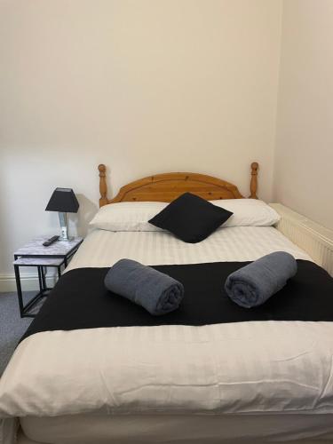 a bedroom with a bed with two pillows on it at Dinorwic Lodge in Liverpool