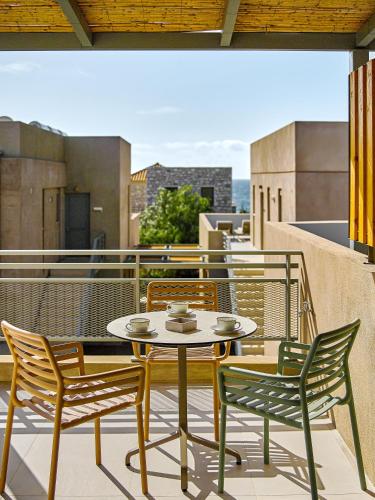 a patio with a table and chairs on a balcony at Callisto Seaside Homes & Suites in Marathopolis