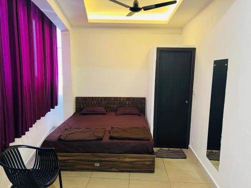a bedroom with a bed and a ceiling fan at AROMA INN in Kalpetta