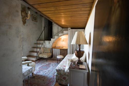 a living room with a bed and a stair case at Locanda dei Melograni in Gossolengo
