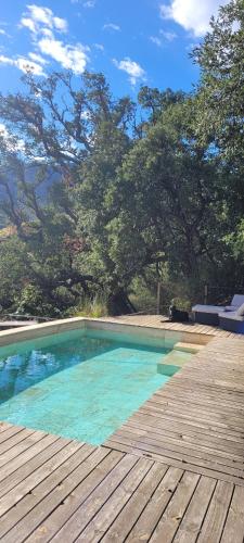a swimming pool on top of a wooden deck at Mas del Roumany in Port-Vendres