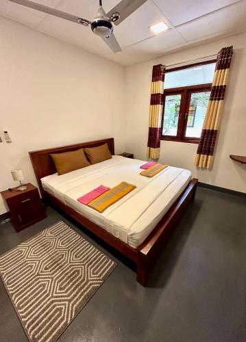 a bedroom with a large bed and a rug at 108 Palms Beach Resort in Trincomalee