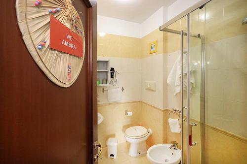 a bathroom with a toilet and a glass shower at Alla fiera di Roma in Ponte Galeria