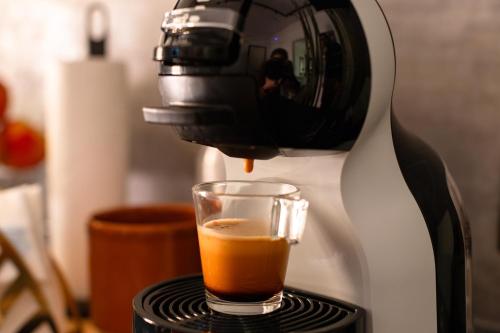a coffee maker is making a cup of coffee at Guest House Al Viale in Caltagirone
