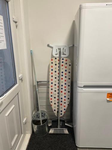 a refrigerator with a whisk next to a door at Dinorwic Lodge in Liverpool