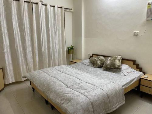 a bedroom with a bed with two pillows on it at Bandra west 2bhk in Mumbai