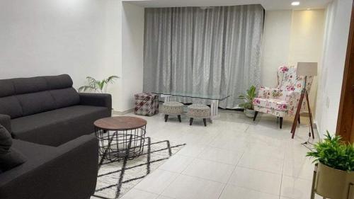 a living room with a couch and a table and chairs at Bandra west 2bhk in Mumbai