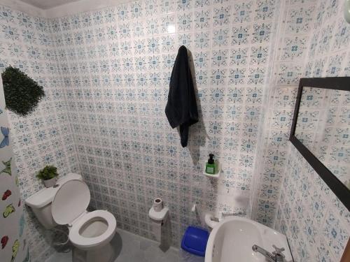 a bathroom with a toilet and a sink at ZIPA HOSTEL in Zipaquirá