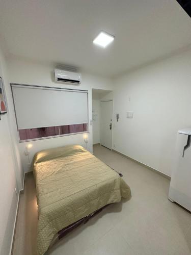 a bedroom with a bed in a white room at Apartamento in Rio de Janeiro