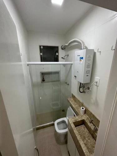 a small bathroom with a toilet and a sink at Apartamento in Rio de Janeiro