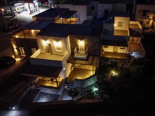 an aerial view of a house at night with lights at Palos Studios in Livadion