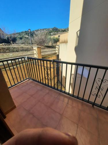 a balcony with a black railing and a tile floor at Casa Cotis Beceite in Beceite