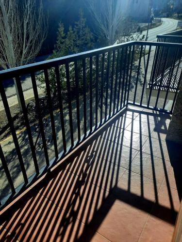 a metal railing on a balcony with its shadows at Casa Cotis Beceite in Beceite