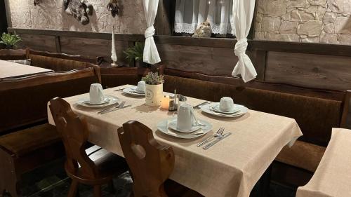 a table in a restaurant with a white table cloth at Haus Tauern Am See in Heiterwang