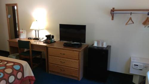 a hotel room with a desk with a television on it at Super 8 by Wyndham Thurmont in Thurmont