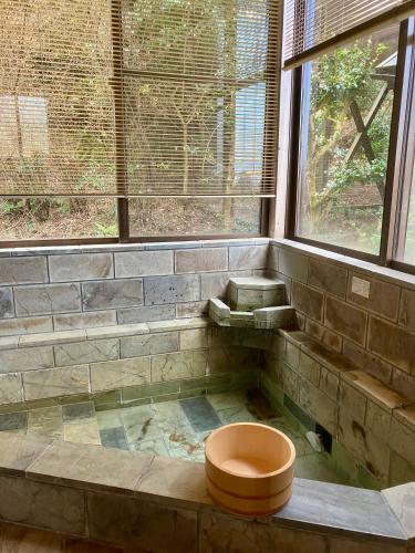 a bathroom with a toilet in the corner of a room at 南箱根 熱海 貸切別荘 リゾートハウス トモ in Atami