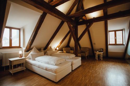 a bedroom with a white bed in a attic at Hotel "Alter Pfarrhof" in Nabburg
