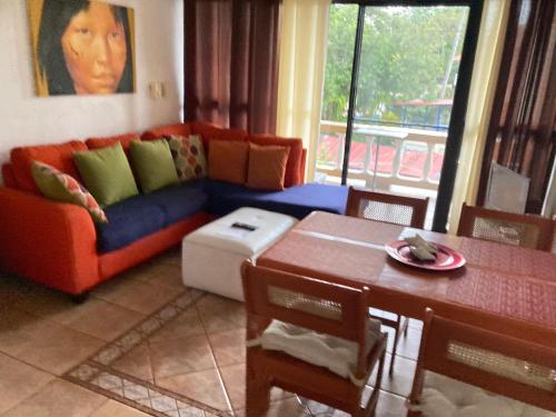 a living room with a couch and a table at Cita del Sol City Apartments in Cabarete