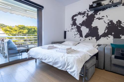 a bedroom with a world map on the wall at Cozy Riviera Apartment in Varkiza