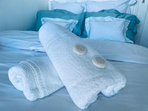 two towels on top of a bed at Luxury Apartment with amazing SEA view at Cap d'Antibes in Antibes