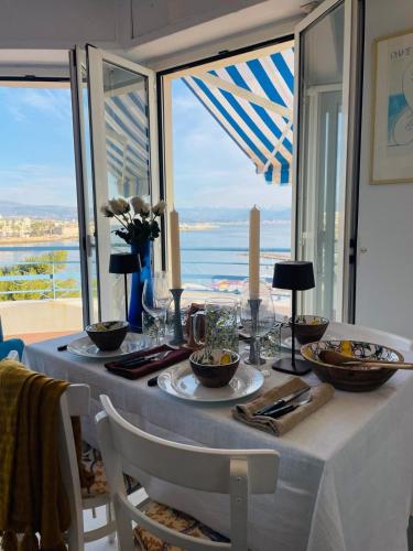 a dining room table with a view of the ocean at Luxury Apartment with amazing SEA view at Cap d'Antibes in Antibes