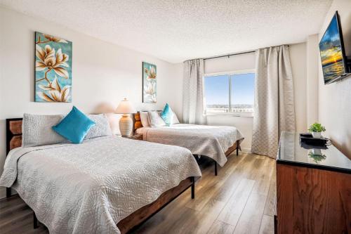 a hotel room with two beds and a window at Sand Castle 2901 in Clearwater Beach
