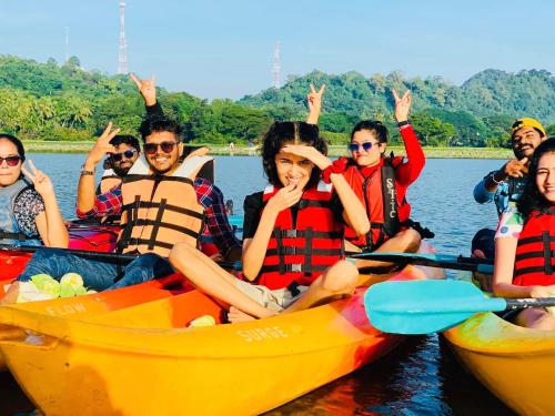 a group of people in kayaks on the water at Lotus cool hotel and restaurant in Ibbagomuwa