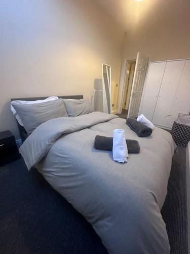 a large bed with two towels on top of it at City centre apartment in Sunderland