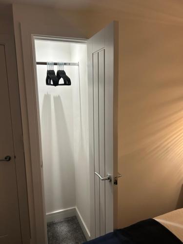a bedroom with two pairs of shoes on a door at THE ARCHERS in Glastonbury