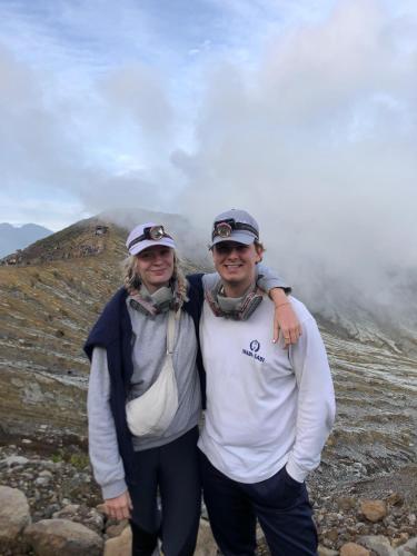 a man and woman standing on top of a mountain at Ijen Transito 2 HOMESTAY in Ketapang