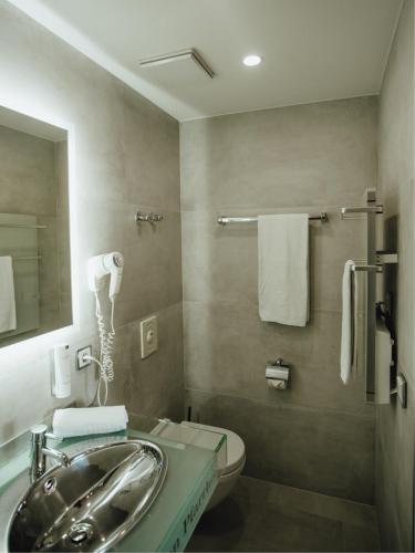a bathroom with a sink and a toilet at Hotel "Alter Pfarrhof" in Nabburg