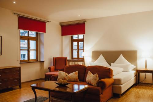 a living room with a couch and a table at Hotel "Alter Pfarrhof" in Nabburg