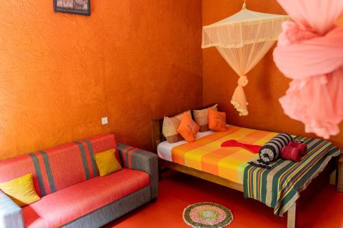 a bedroom with a bed and a couch in it at Hotel Hideaway Garage in Dambulla