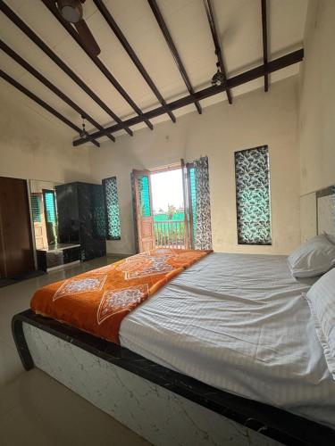 a large bed in a room with a window at Green Vista Villa in Trimbak