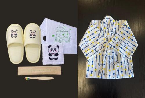 a pair of slippers and a panda shirt and a pen at Shirahama Onsen Kisyu Hanto in Shirahama