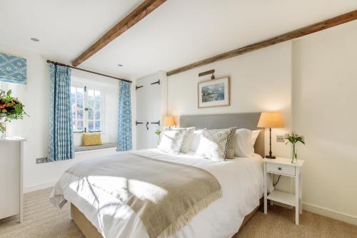 a bedroom with a large bed and a window at Cottage in Tranquil Hamlet in Salcombe