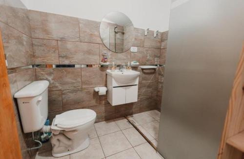 a bathroom with a toilet and a sink at Boulevard One in General Pico