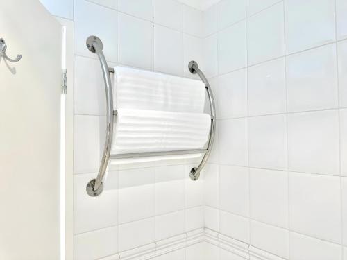 a bathroom with a shower with white tiles at Tranquil Haven in Cape Town