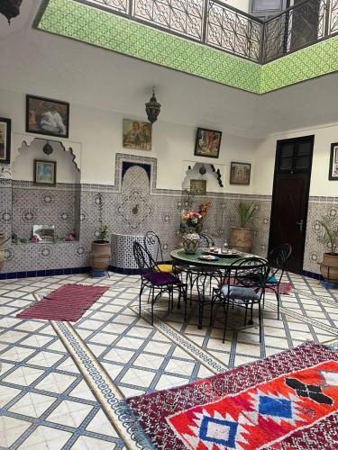 a room with a table and chairs in a building at HOTEL EL AMAL in Marrakech
