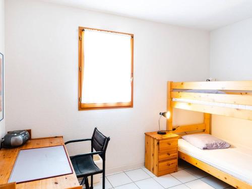 - une chambre avec un bureau et des lits superposés dans l'établissement Pavillon Climatisé 3 Pièces avec Terrasse et Garage, Proche Plage - 4 Couchages - FR-1-409-68, à Narbonne-Plage