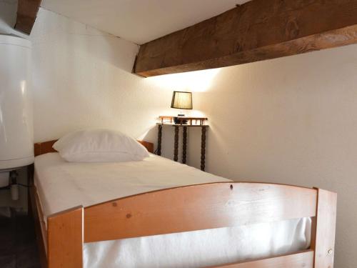 a bed in a small room with a lamp at Maison 2 Pièces Mezzanine Proche Plage, Animaux Acceptés, Parking - FR-1-229D-55 in Fleury