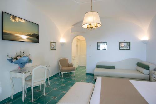 a living room with a couch and a table at Hotel Pellegrino in Praiano